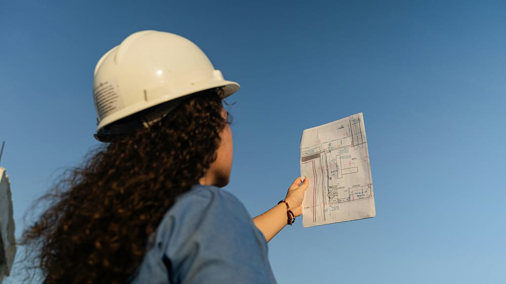 female property developer reading plans in preparation for 2025